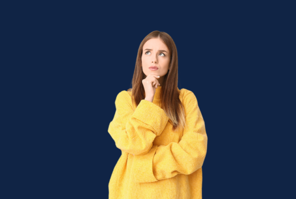 Women in yellow jumper thinking