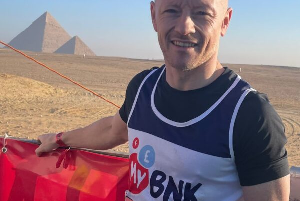 MyBnk runner Darren Collins smiles in front of the pyramids in Gize before running a half marathon in Cairo